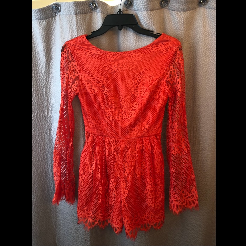 New with tags, never worn. Long sleeve romper.